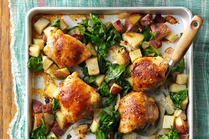 Baking sheet of chicken thighs, veggies and diced potatoes