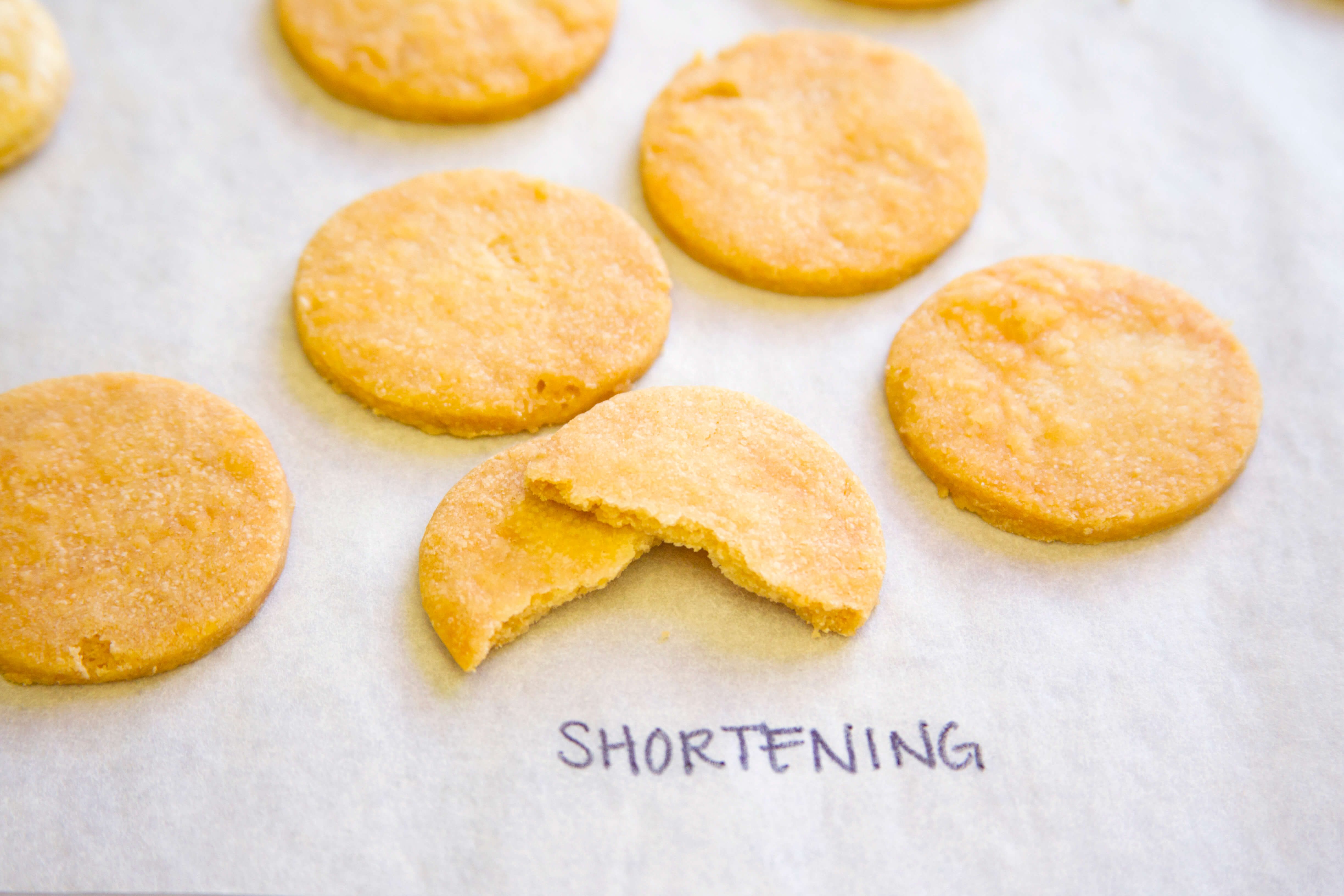 Pie crust with shortening taste test - cookie-shaped pieces shown on a baking sheet labeled with "shortening"