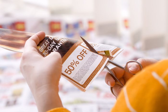 Woman cutting abstract discount coupon