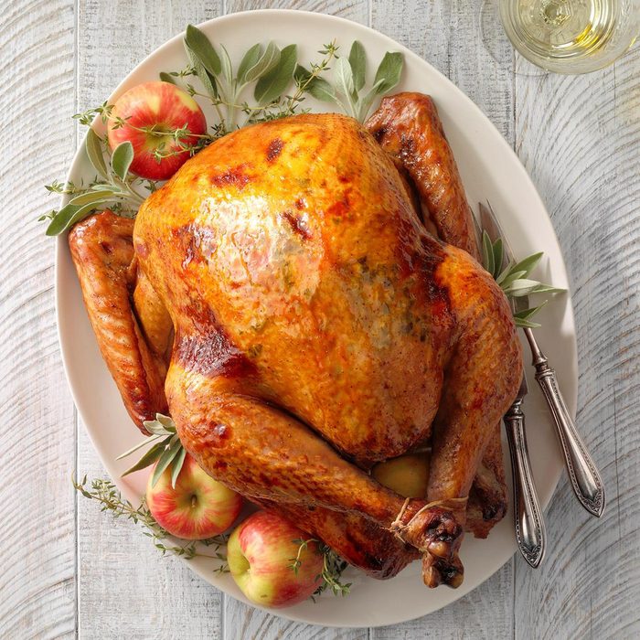 Apple sage roasted turkey on wooden surface