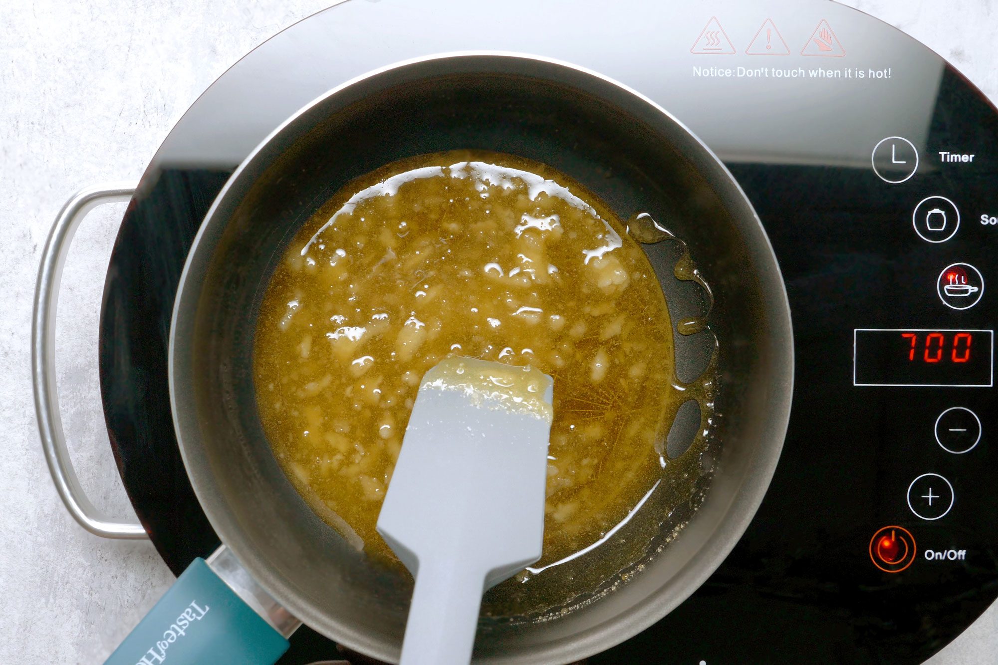 Cook 3/4 cup of sugar over low heat in a large heavy saucepan