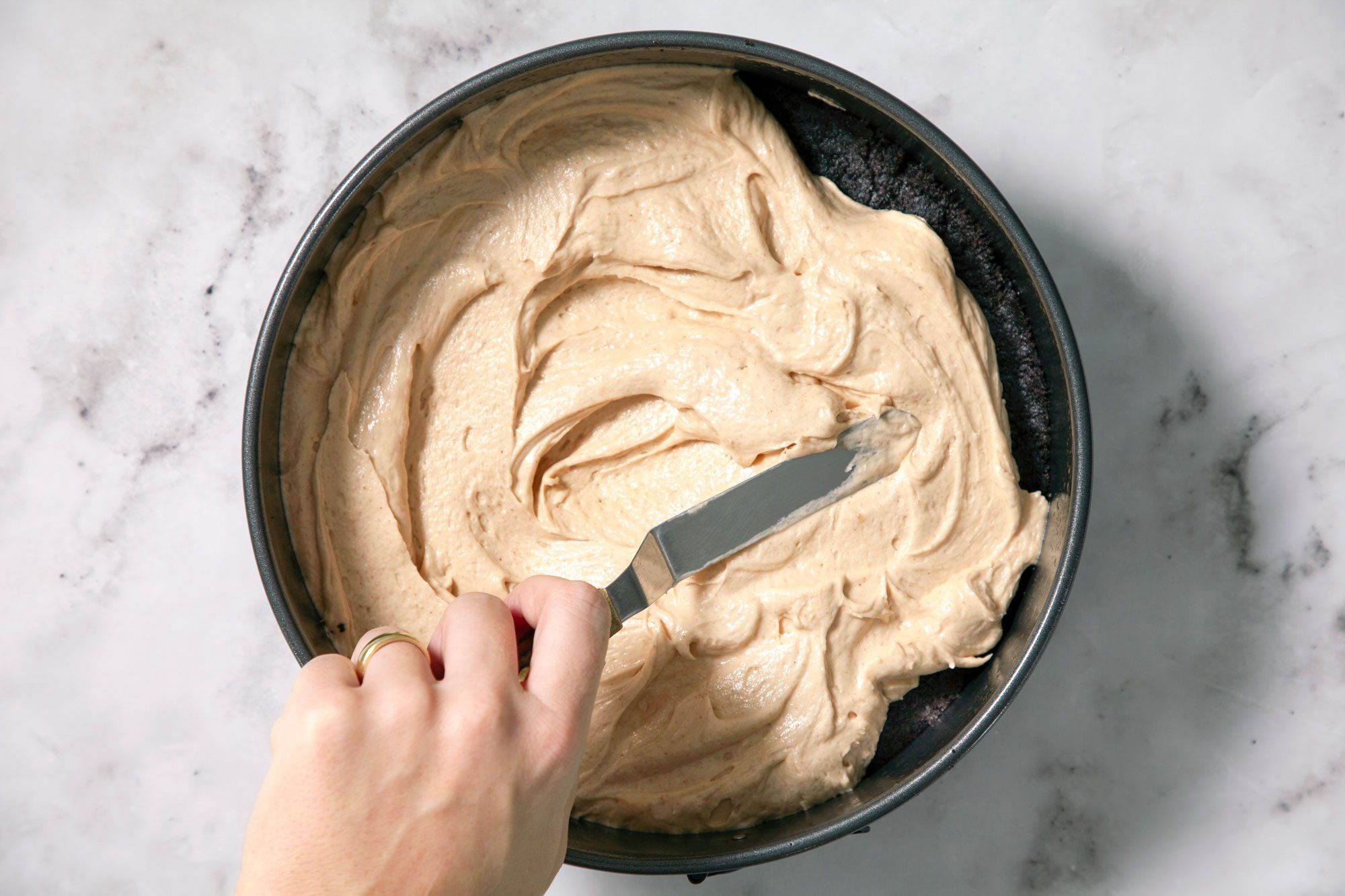Spreading Peanut Butter Mousse on Oreo Cookies Crust