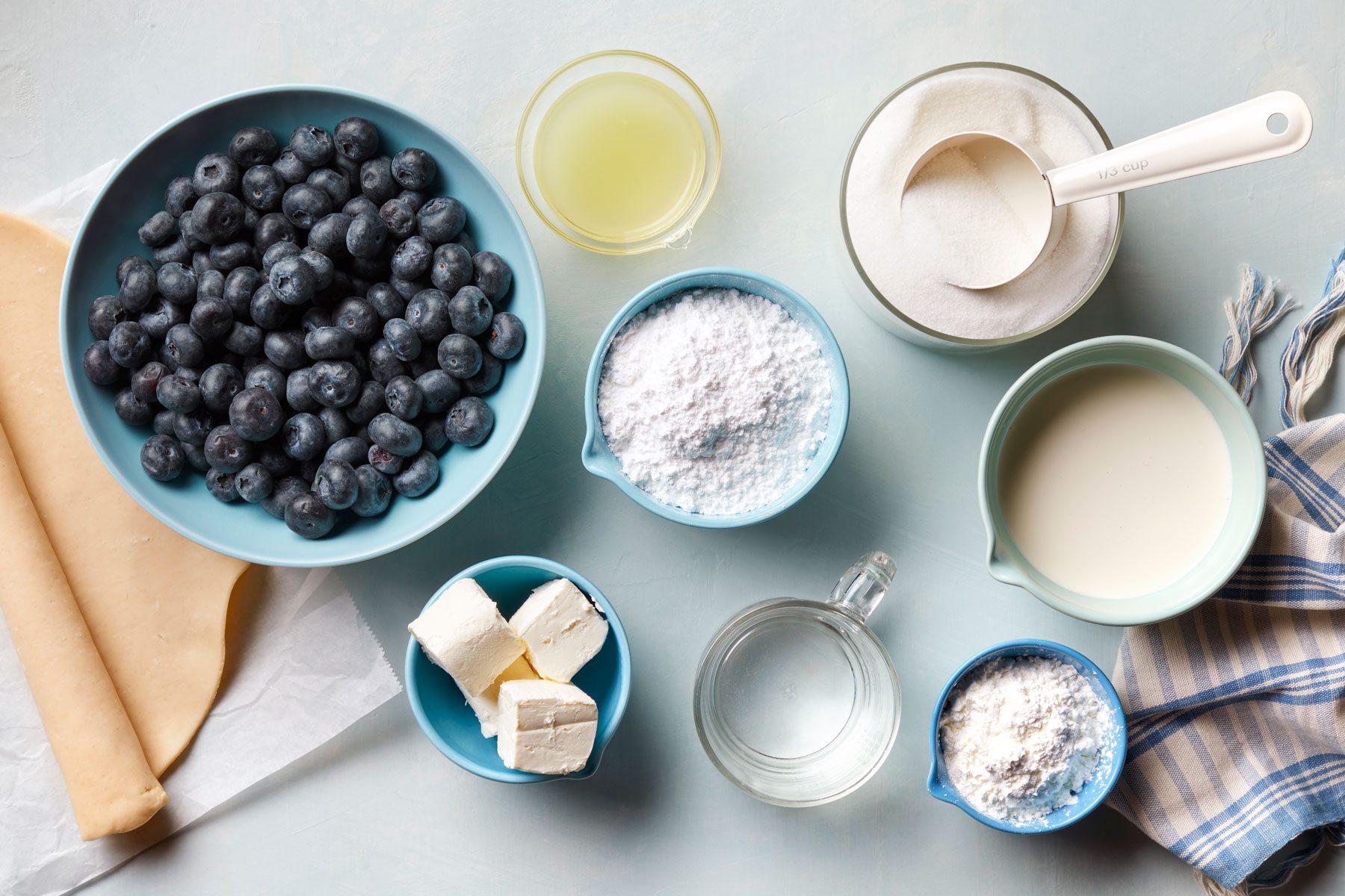 A bowl of blueberries and various ingredients