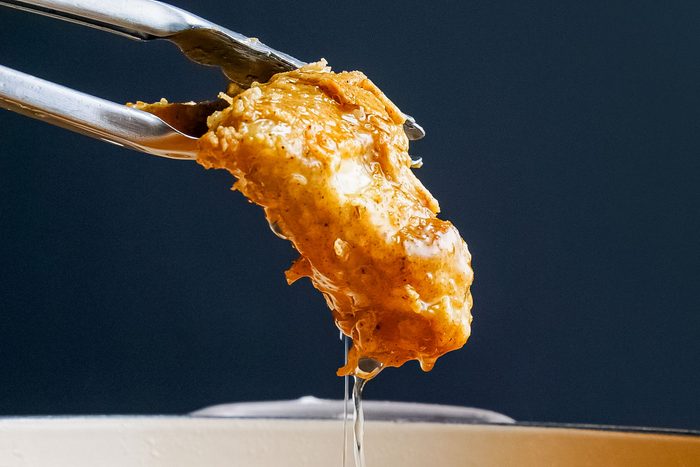 Crispy Fried Chicken Picked with Cooking Tong