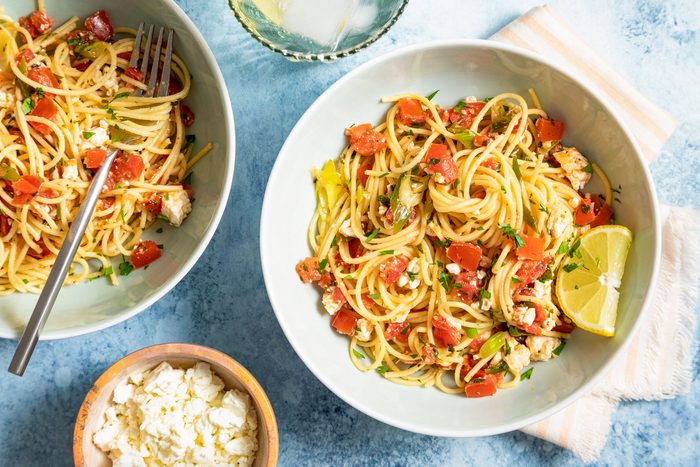 Greek Spaghetti Served in Large Ceramic Bowl on Blue Background