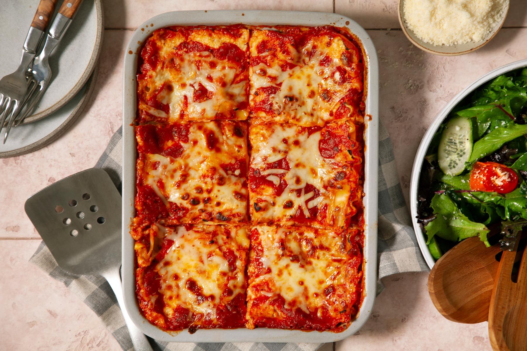 A Dish of Lasagna With Cheese and Salad