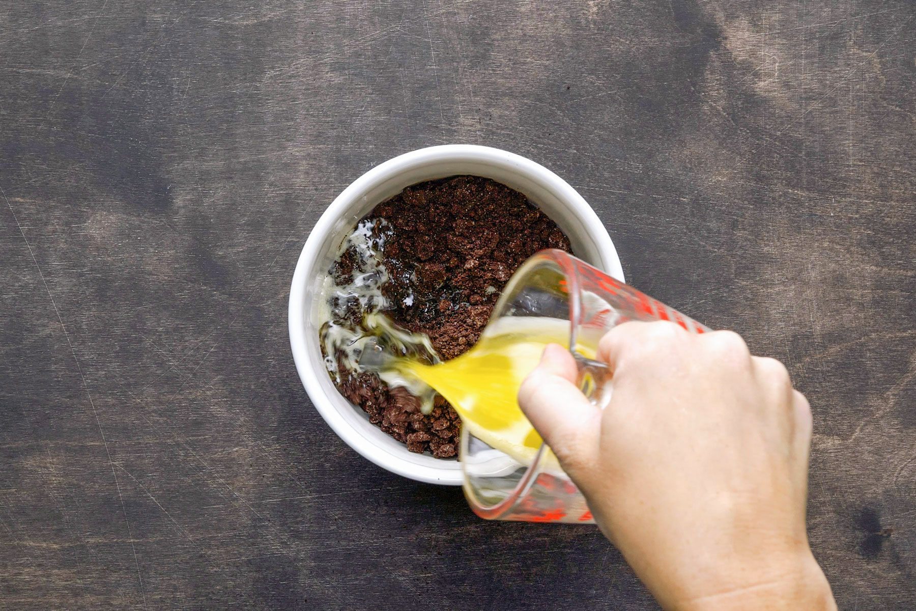 ouring melted butter in crushed oreo