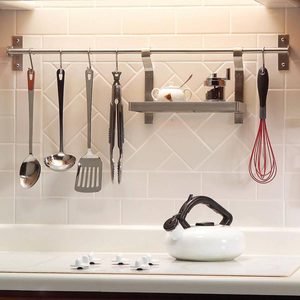 Kitchen tools hanging from a bar over the counter