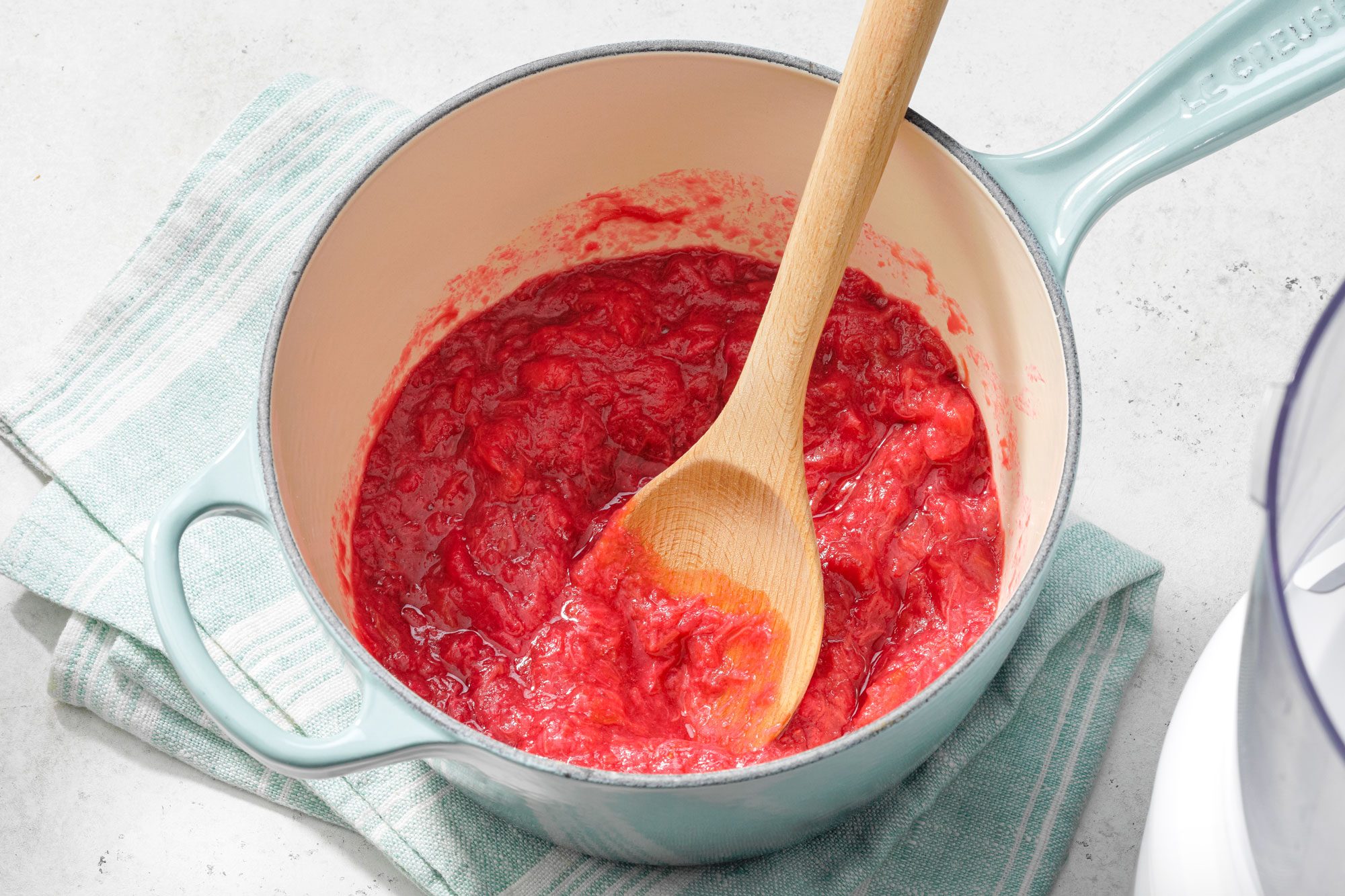 Rhubarb Sauce and Wooden Spatula in a Small Pan on a Piece of Cloth