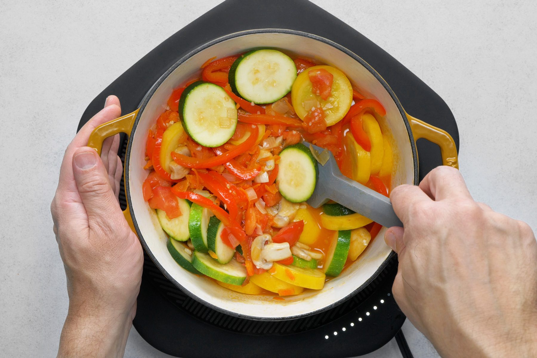 A person holding a pot of food