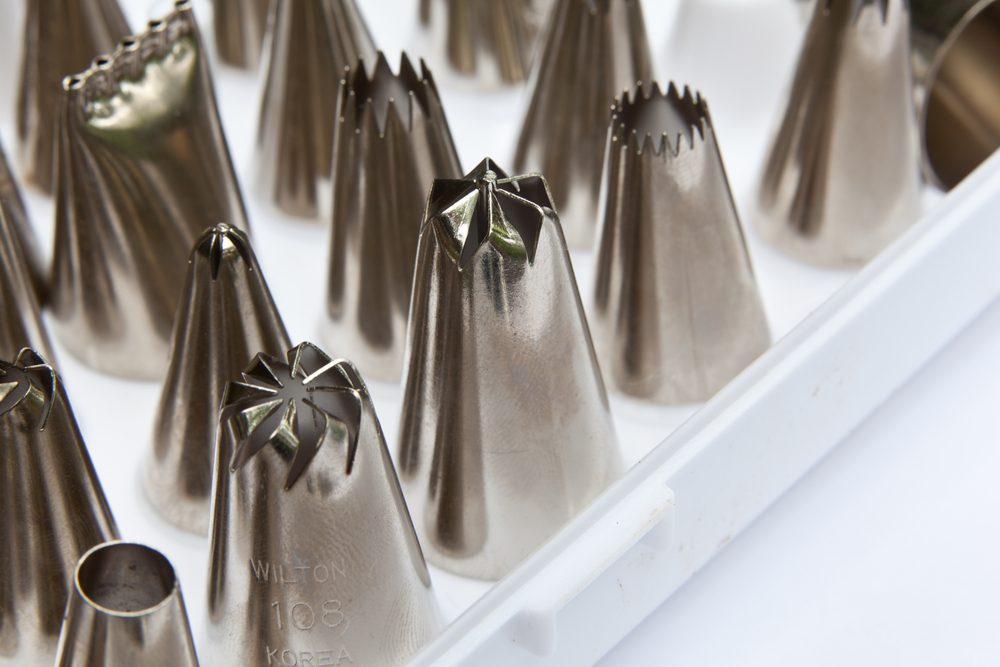 A closeup photo of metal frosting tips;