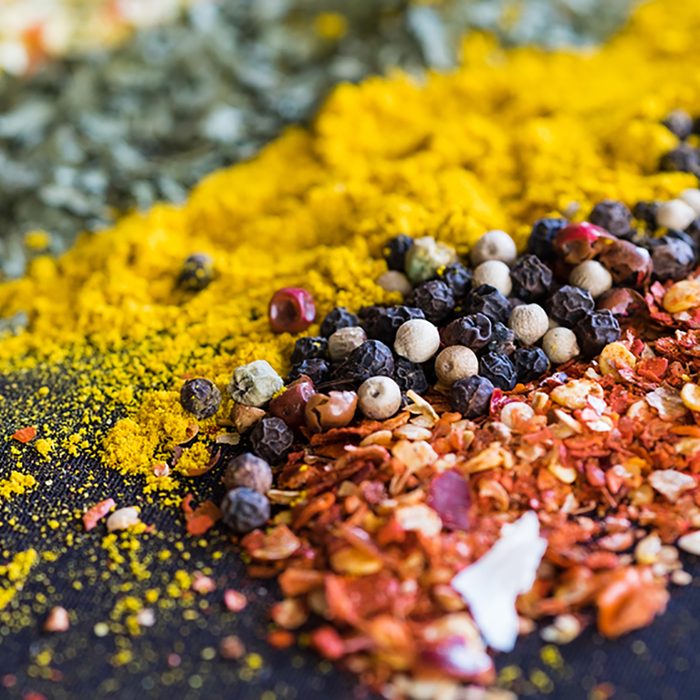 Spices and herbs on a black background; Shutterstock ID 545932456