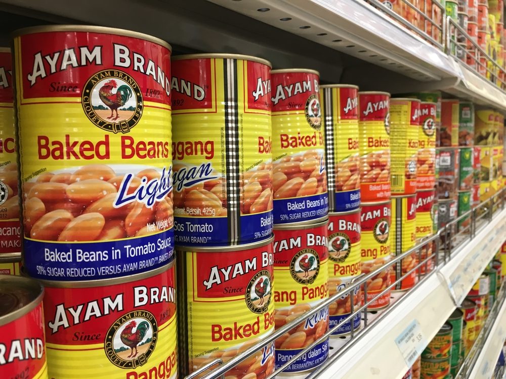 RAWANG, MALAYSIA - SEPTEMBER 15, 2017 : Row of Ayam (Chicken) Brand Baked Beans cans display on the shelf at hypermarket. Ayam Brand believes only in quality ingredients prepared naturally.
