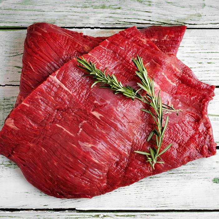 raw fillet of beef brisket on white wooden background