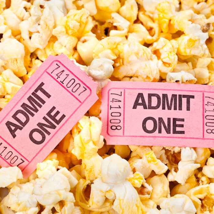 Movie tickets in a pool of freshly popped popcorn