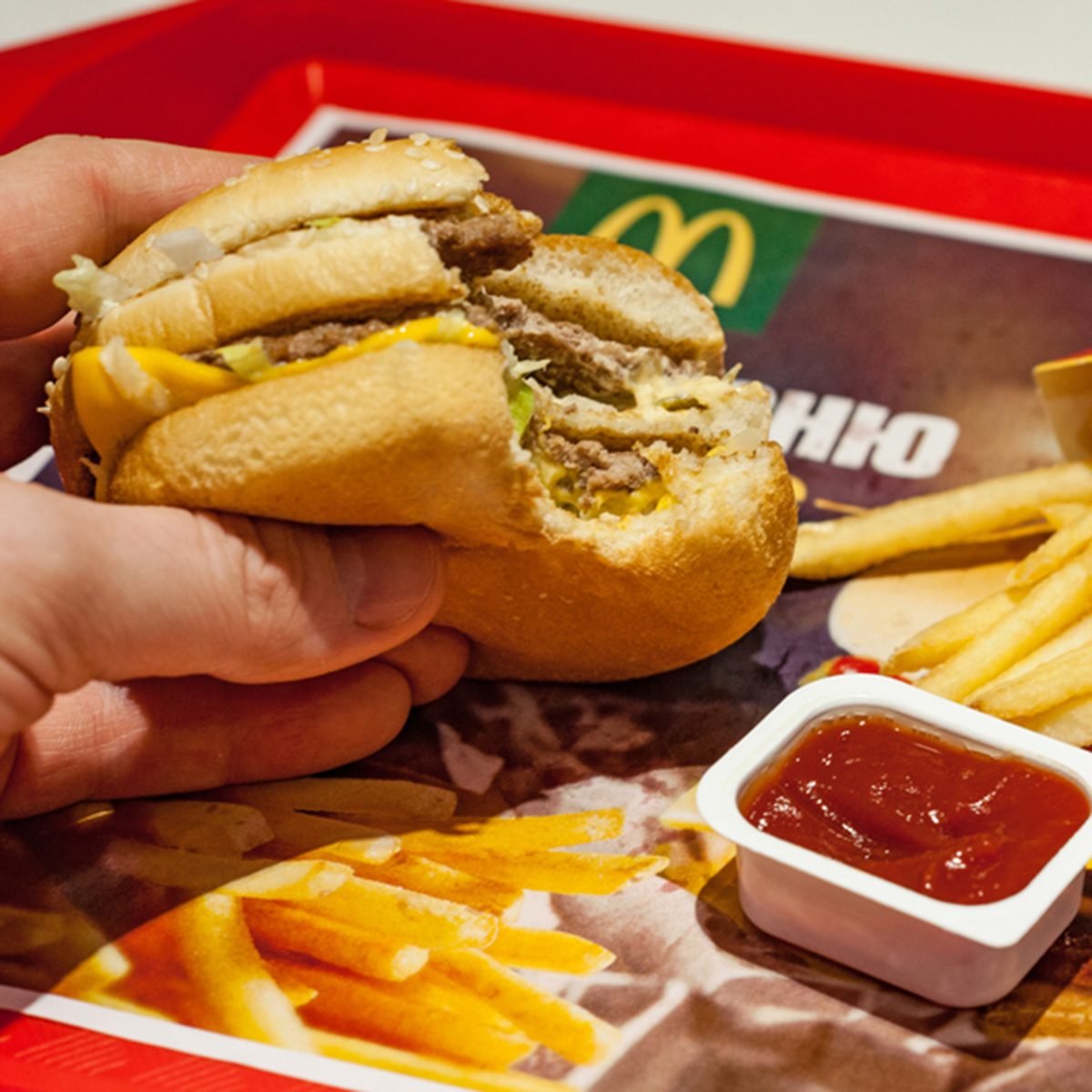 Man is eating at McDonald's restaurant.