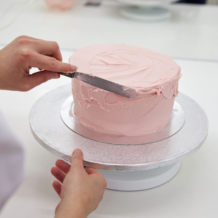 Close Up Of Woman In Bakery Decorating Cake With Icing; Shutterstock ID 467682944; Job (TFH, TOH, RD, BNB, CWM, CM): Taste of Home