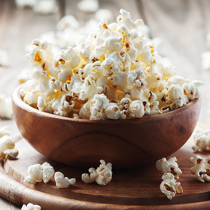 Salt popcorn on the wooden table
