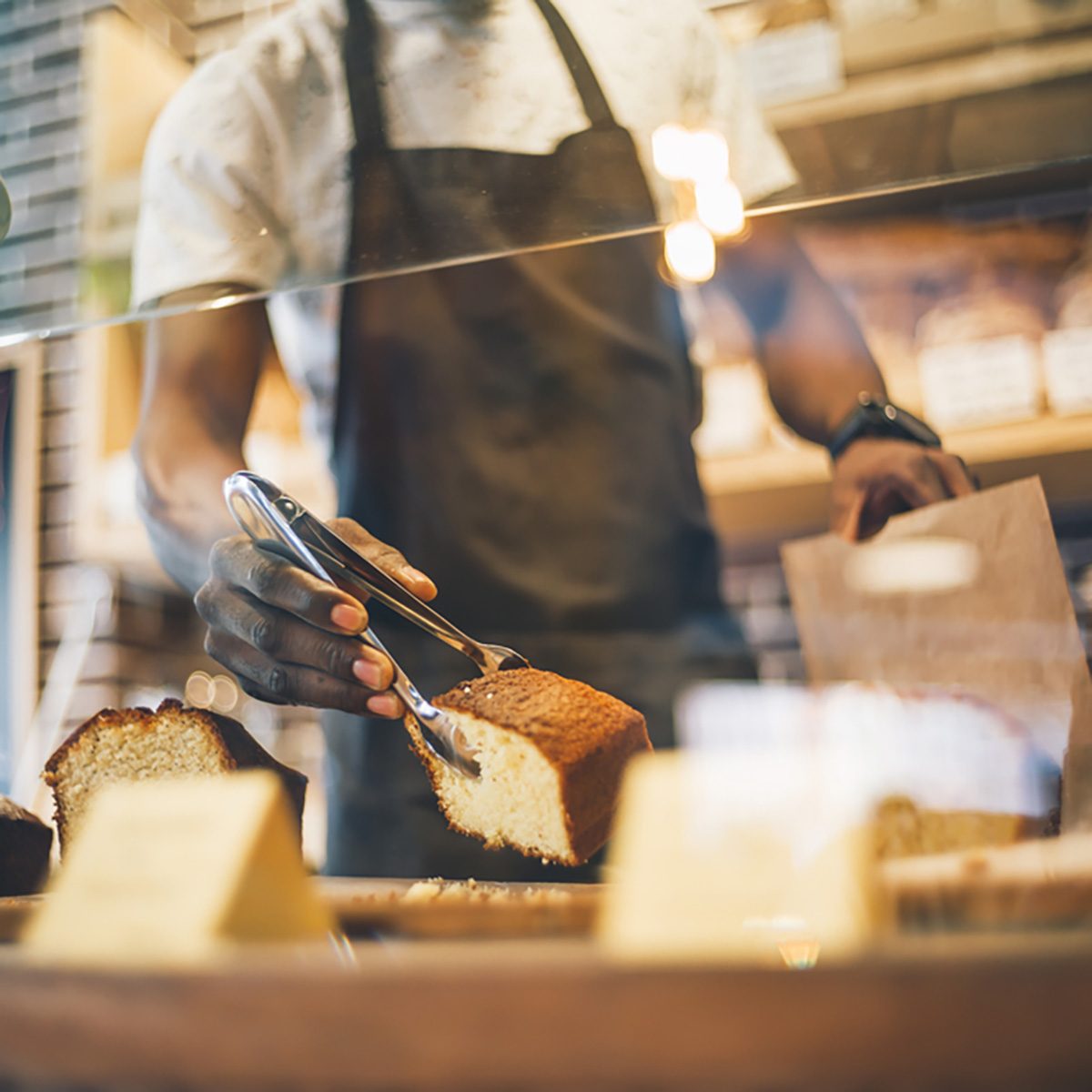 Black man works in pastry shop.