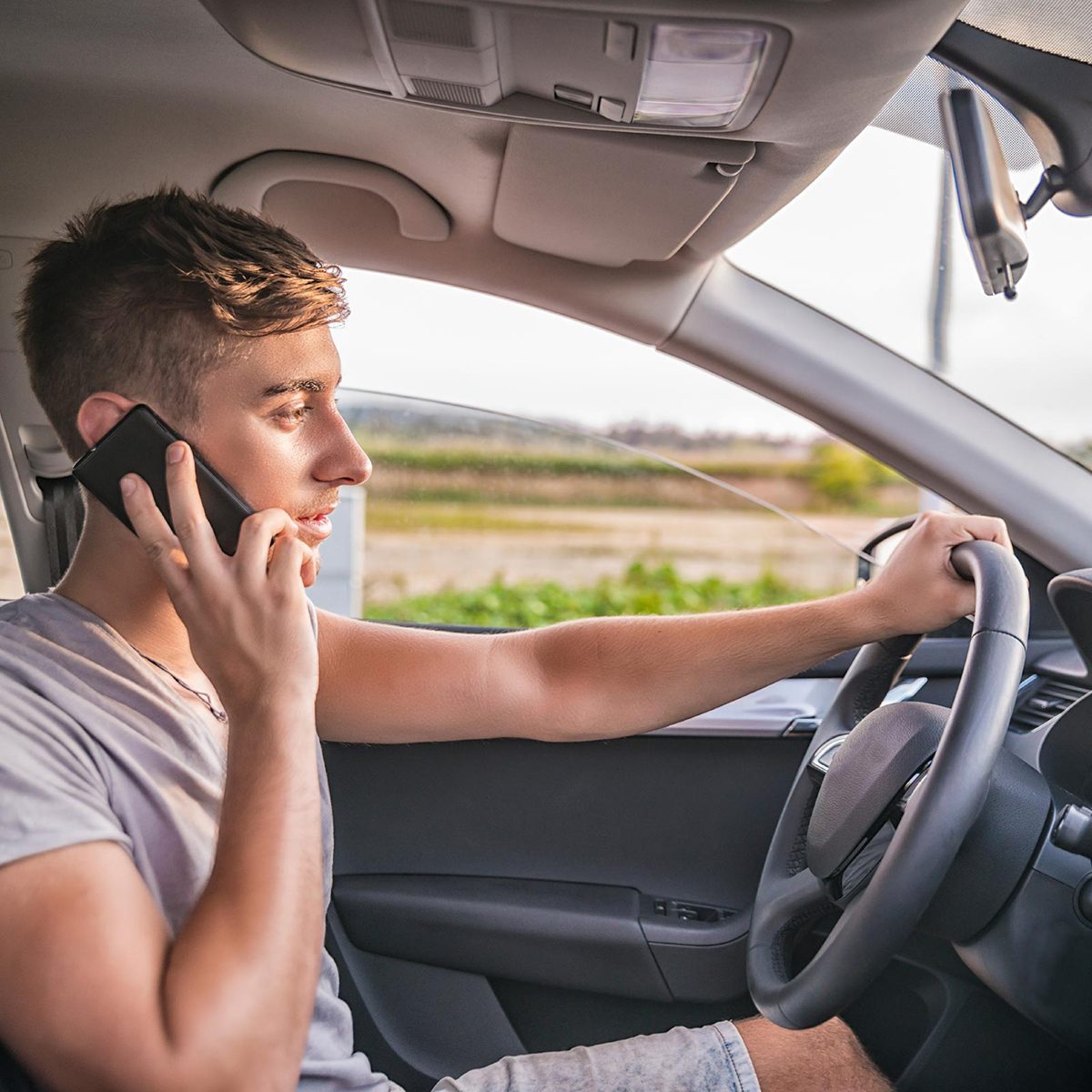 Kid driving car while on phone