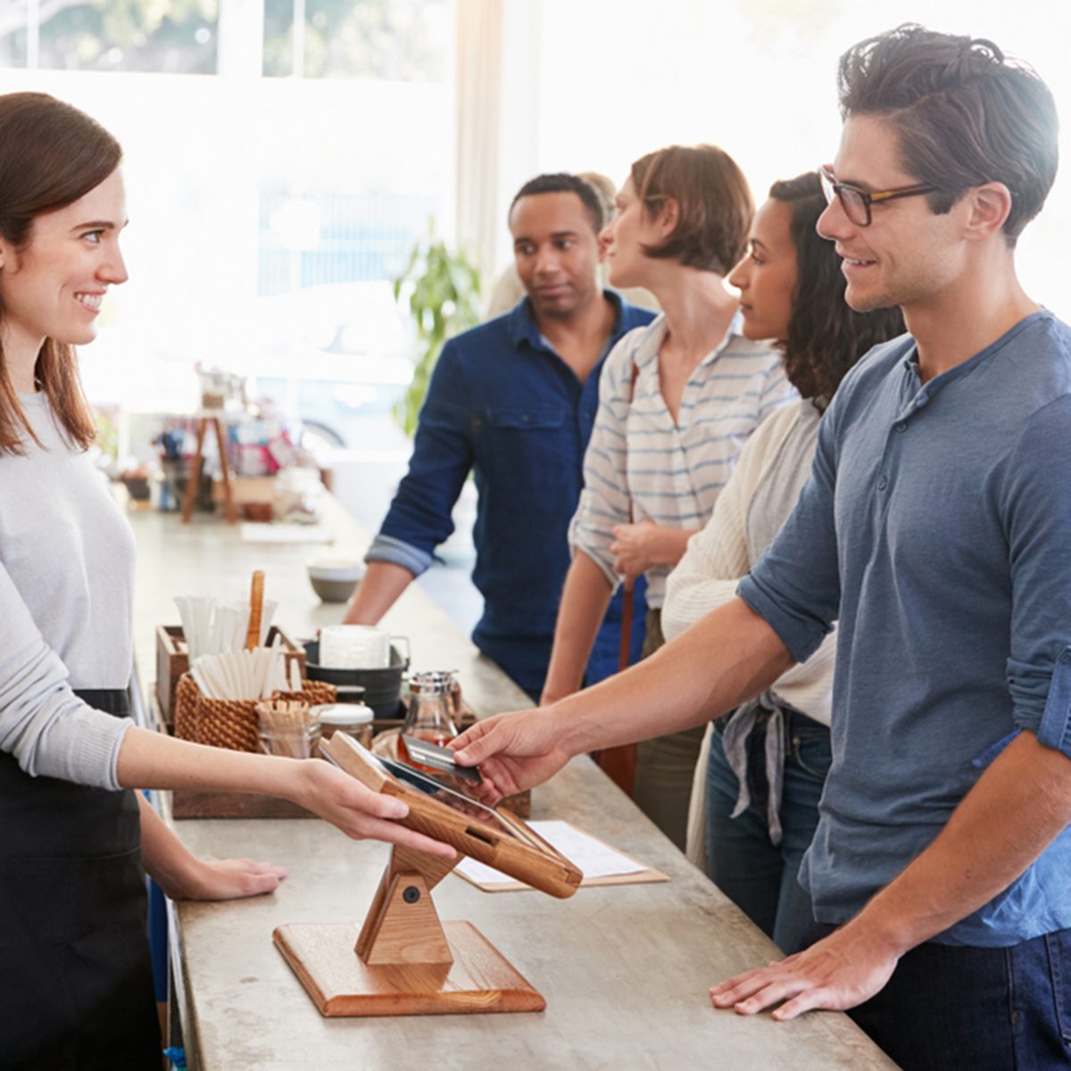 Customers queuing to order and pay at a coffee shop