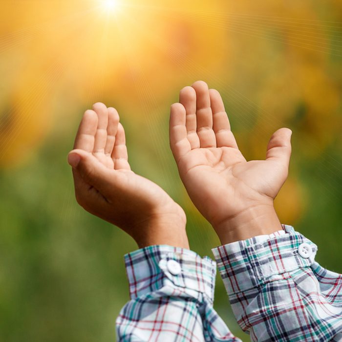 Children's open empty hands with palms up.