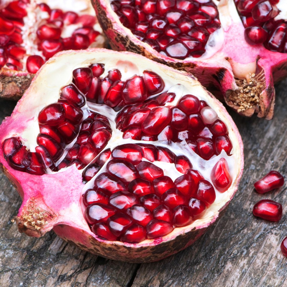 Juicy pomegranates on wood