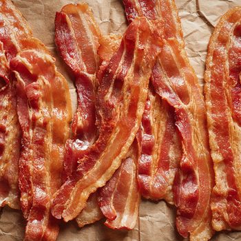 Cooked bacon rashers on parchment