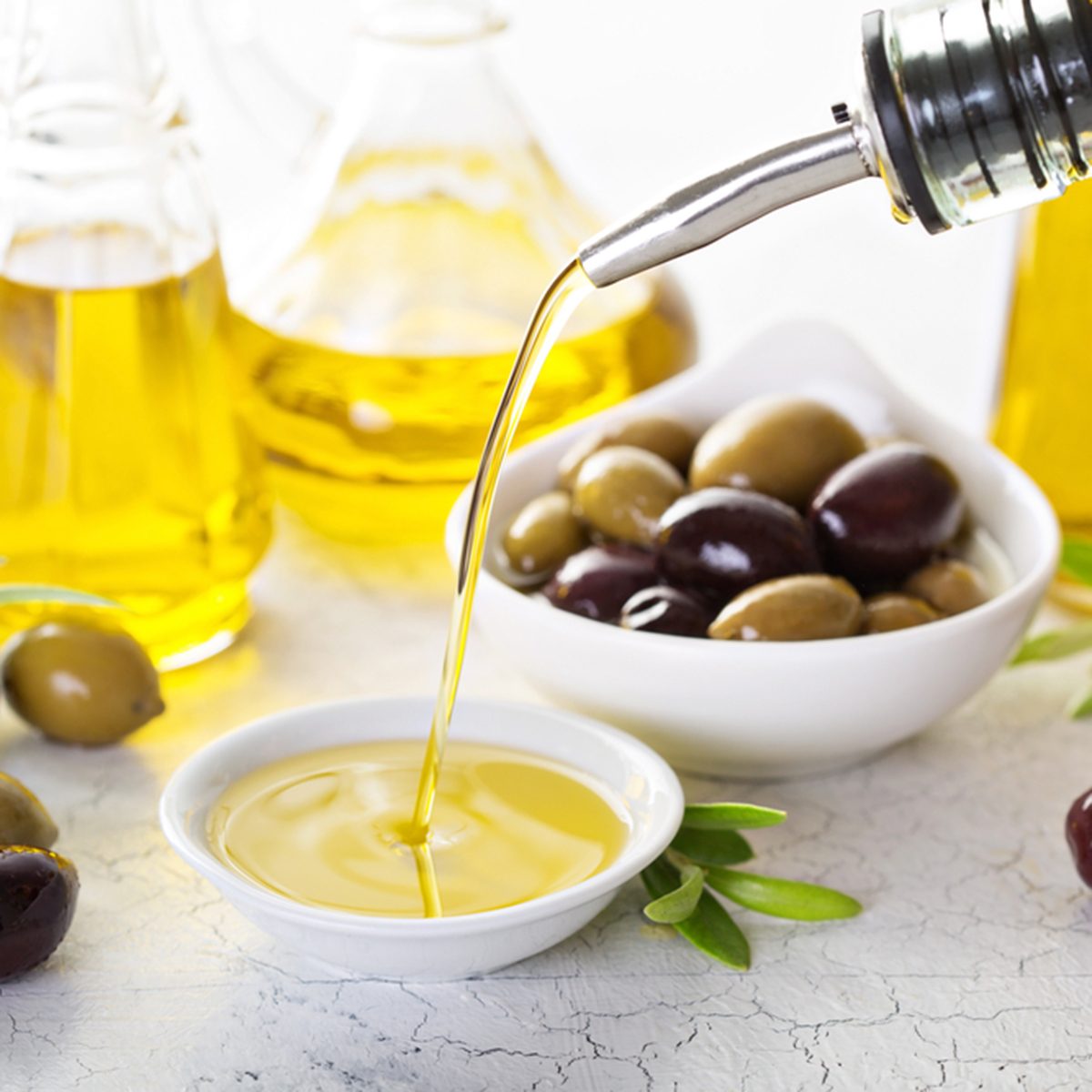 Olive oil in vintage bottles and small bowl