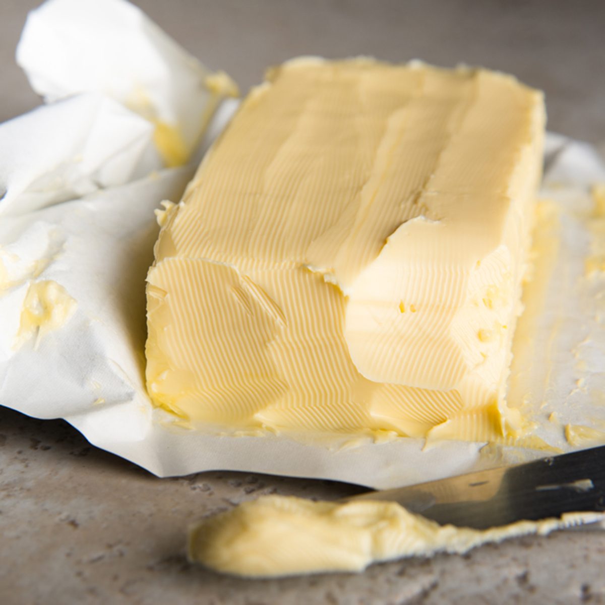 Large Softened Stick of Butter on Wrapping Ready to Eat; Shutterstock ID 171461966; Job (TFH, TOH, RD, BNB, CWM, CM): TOH