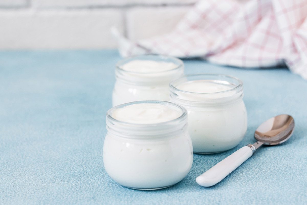 Instant pot homemade yogurt in glass jars on light blue background.