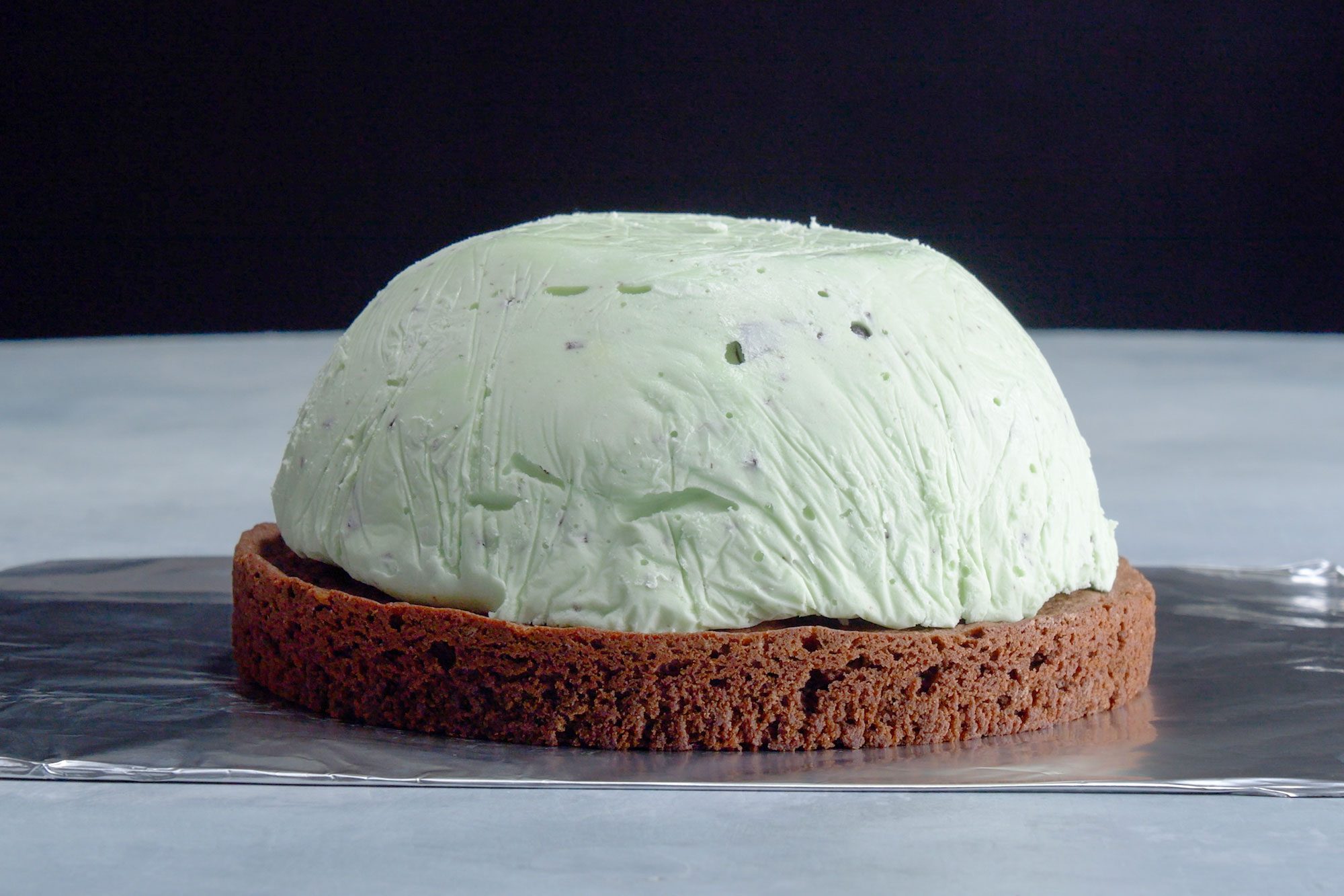 pieces of baked alaska being assemble on tin foil surface