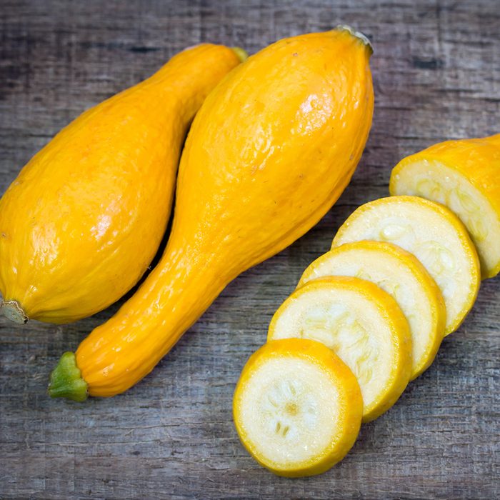 Fresh yellow zucchini on wooden