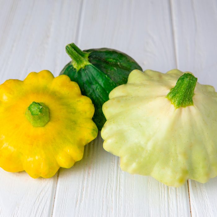 Pattypan Squashes on white board.