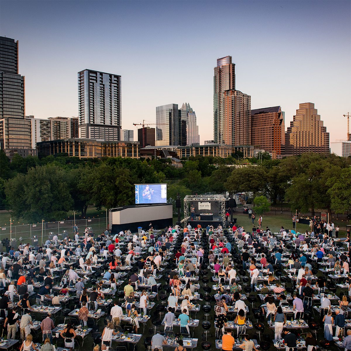 Austin Food + Wine Festival rows of people cooking at tables in Austin texas park