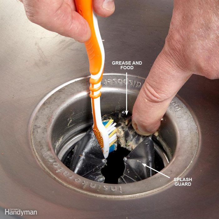 Cleaning garbage disposal with a toothbrush
