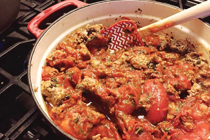cooking tomato sauce on stove for pioneer woman lasagna