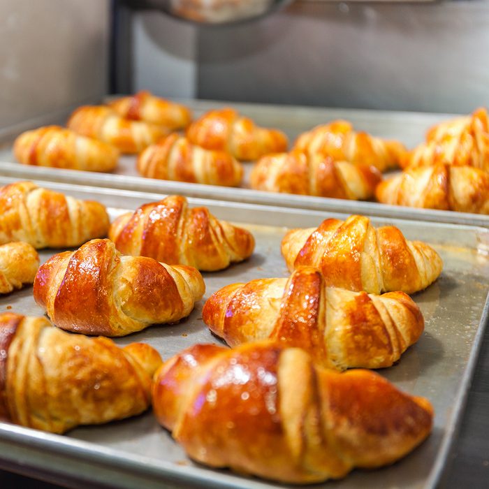 Fresh baked croissants on baking sheet