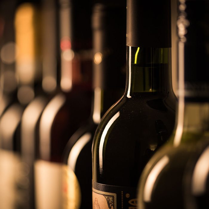 Row of vintage wine bottles in a wine cellar