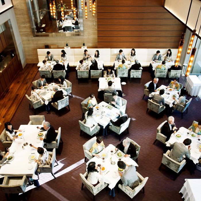 Japanese restaurant, Tokyo. Note: the same four people at each table.