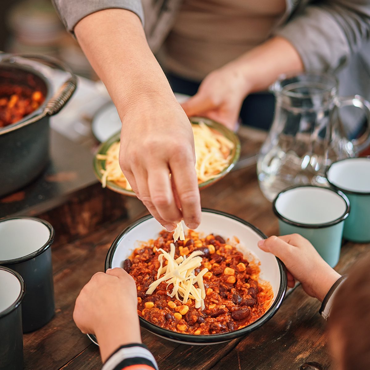 Young Family Eating Chili Con Carne