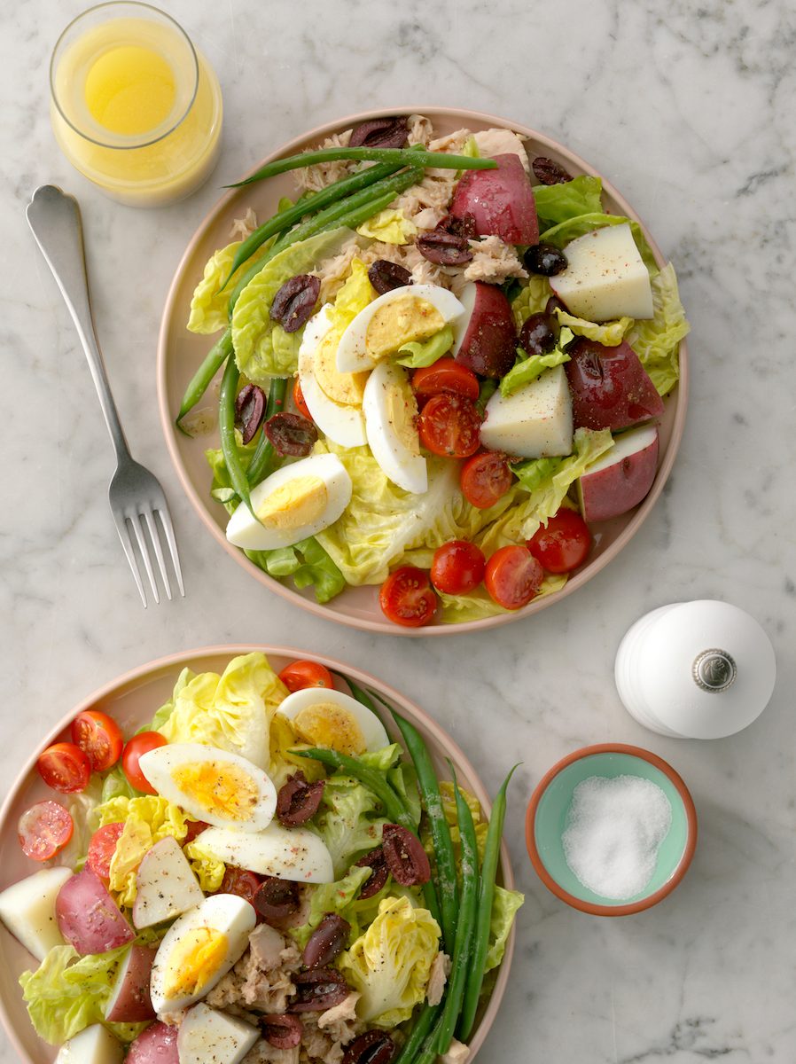 Nicoise salads on table.