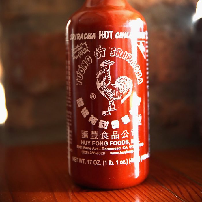 CHICAGO, IL - DECEMBER 12: A bottle of Sriracha hot chili sauce is shown on December 12, 2013 in Chicago, Illinois. Huy Fong Foods, the maker of Sriracha, says it can't ship any more of its sauce until next month because in California, where the sauce is produced, the Department of Public Health is now enforcing stricter guidelines that require sauces be held for 35 days before they are shipped. (Photo Illustration by Scott Olson/Getty Images)