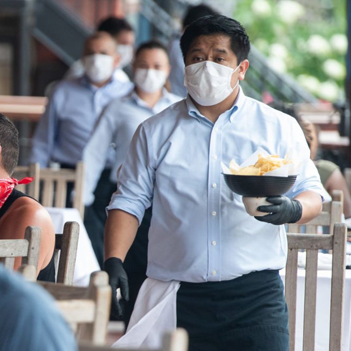 Masked waiters delivering chips