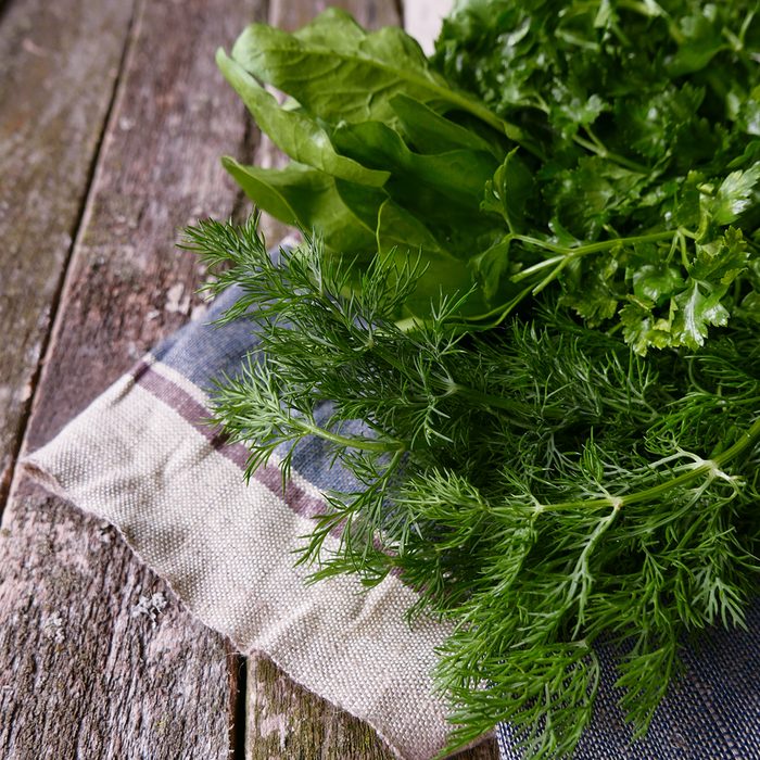 fresh greens on a wooden table linen napkin copyspace