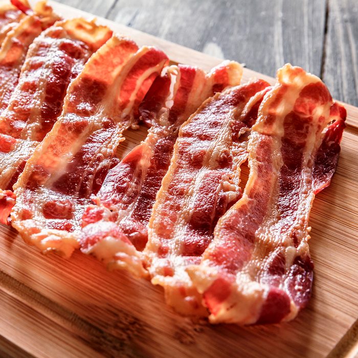 Roasted bacon on cutting board. Ingredient used in making Jam Bread or "Pan de Jamon" a Venezuelan Christmas food.