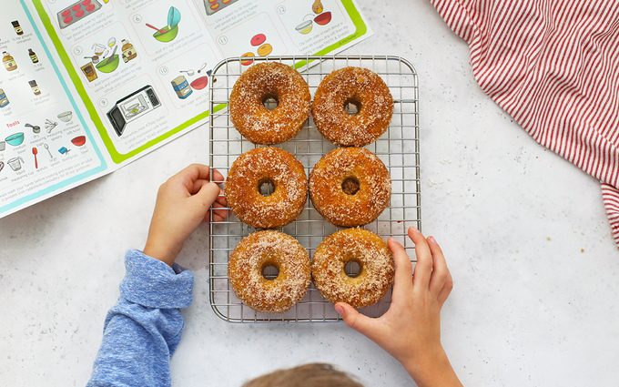 Finished donuts on a metal rack
