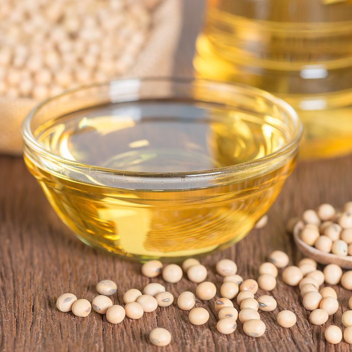 healthy oils Soybean oil and Soybean on wooden table.