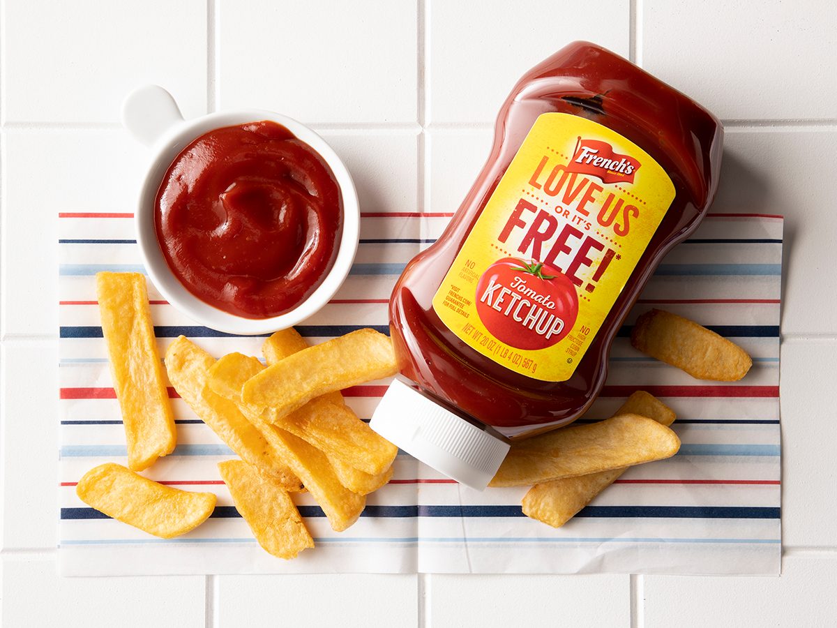Overhead Shot Of French's Ketchup In Bottle With Fries.