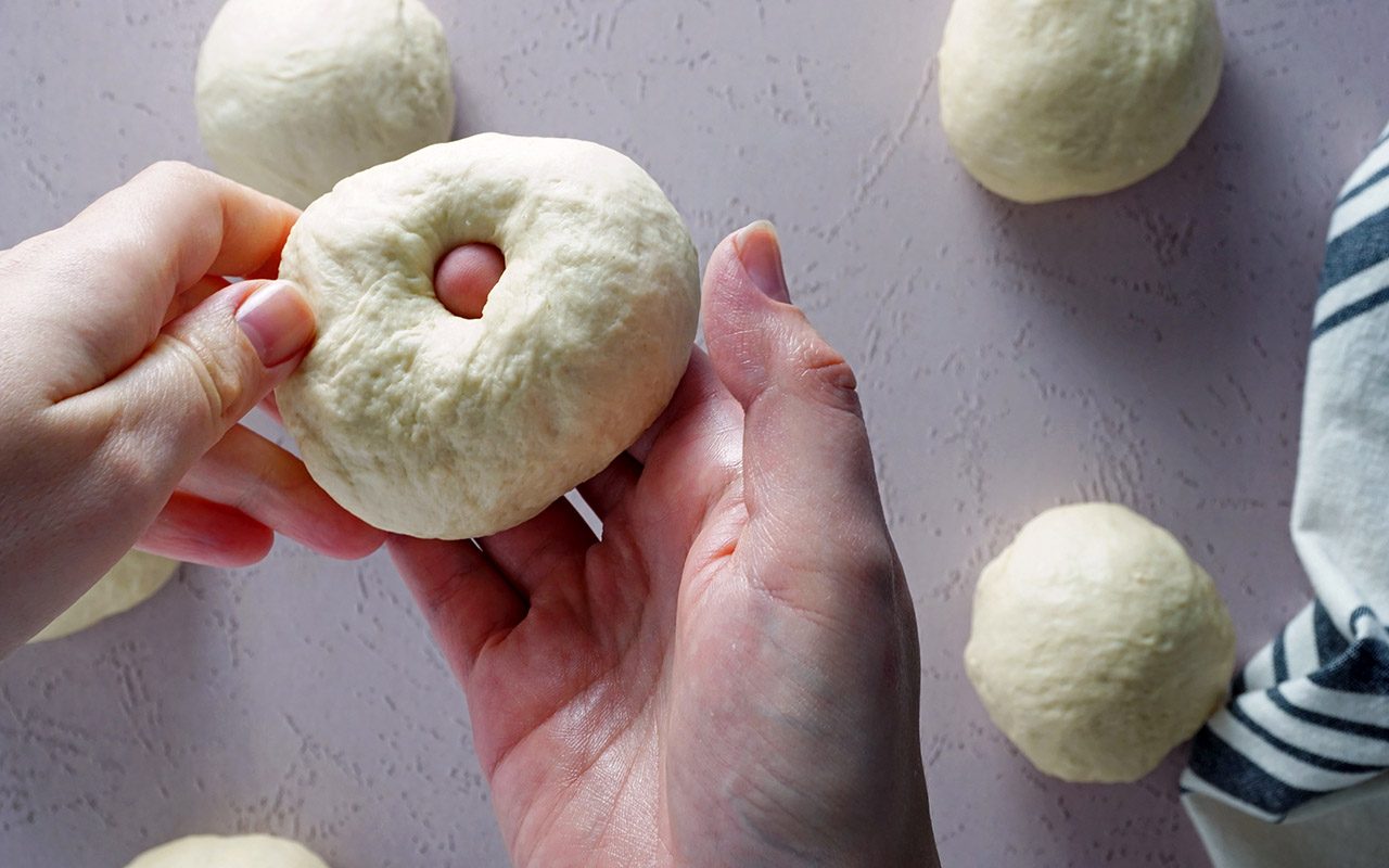 putting hole in bagel by hand Cinnamon Crunch Bagels Panera 041921 Toh 11